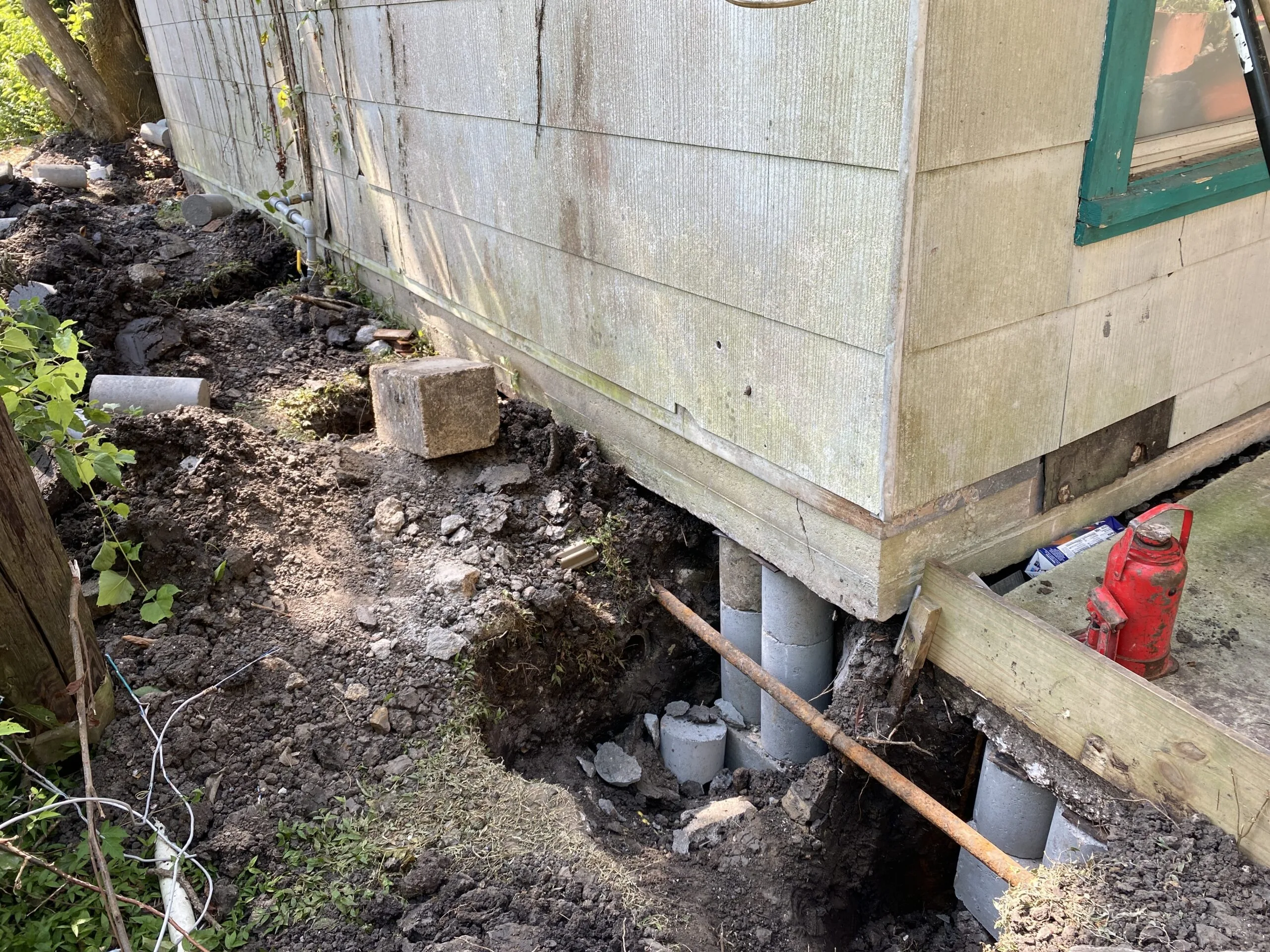 Raised house supported by foundation jacks and piers