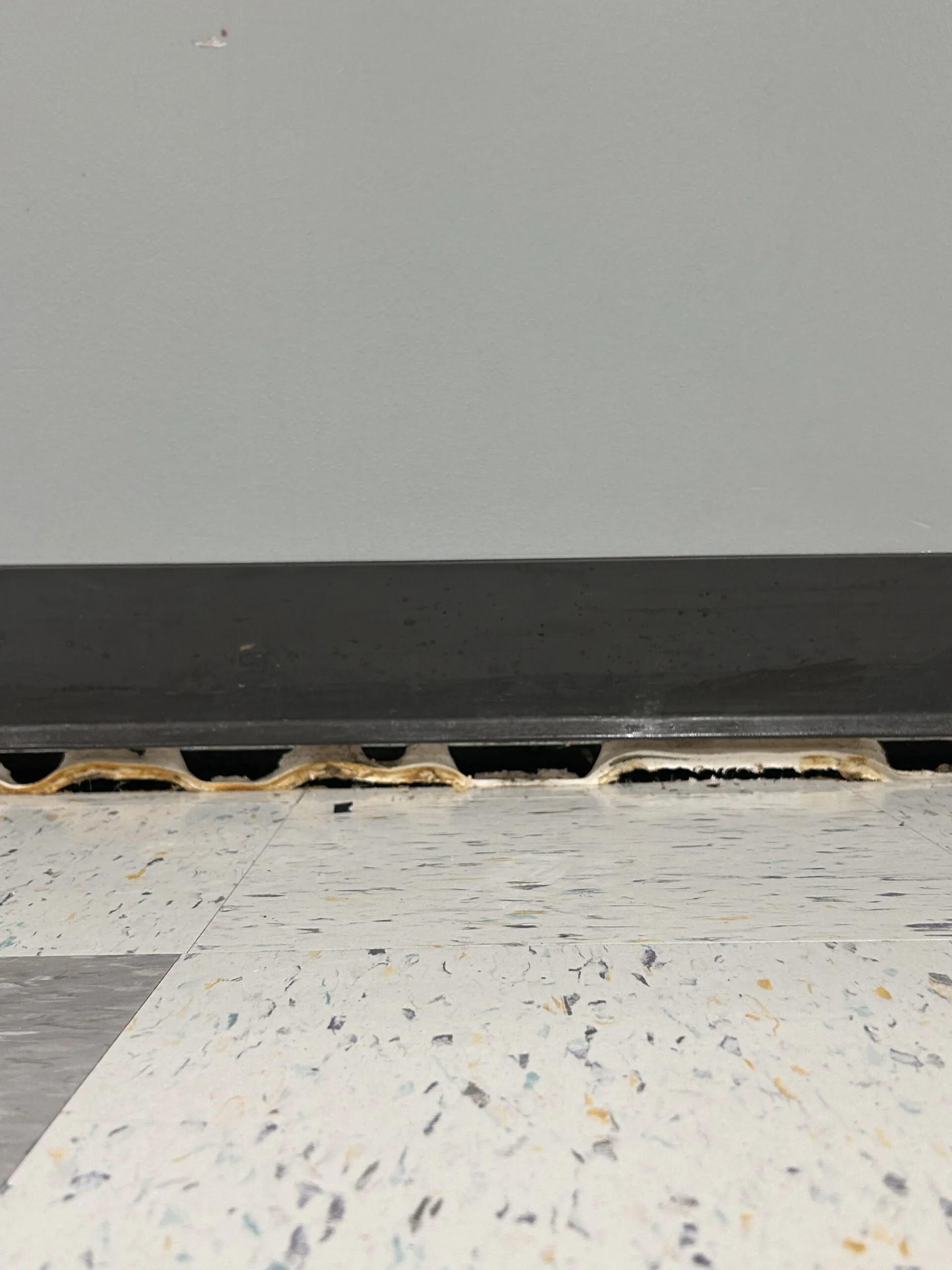 Gap beneath a wall at the floor edge
