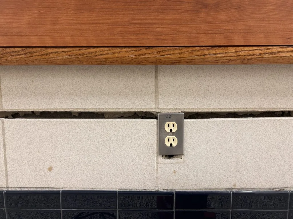 Electrical outlet above a separated wall base
