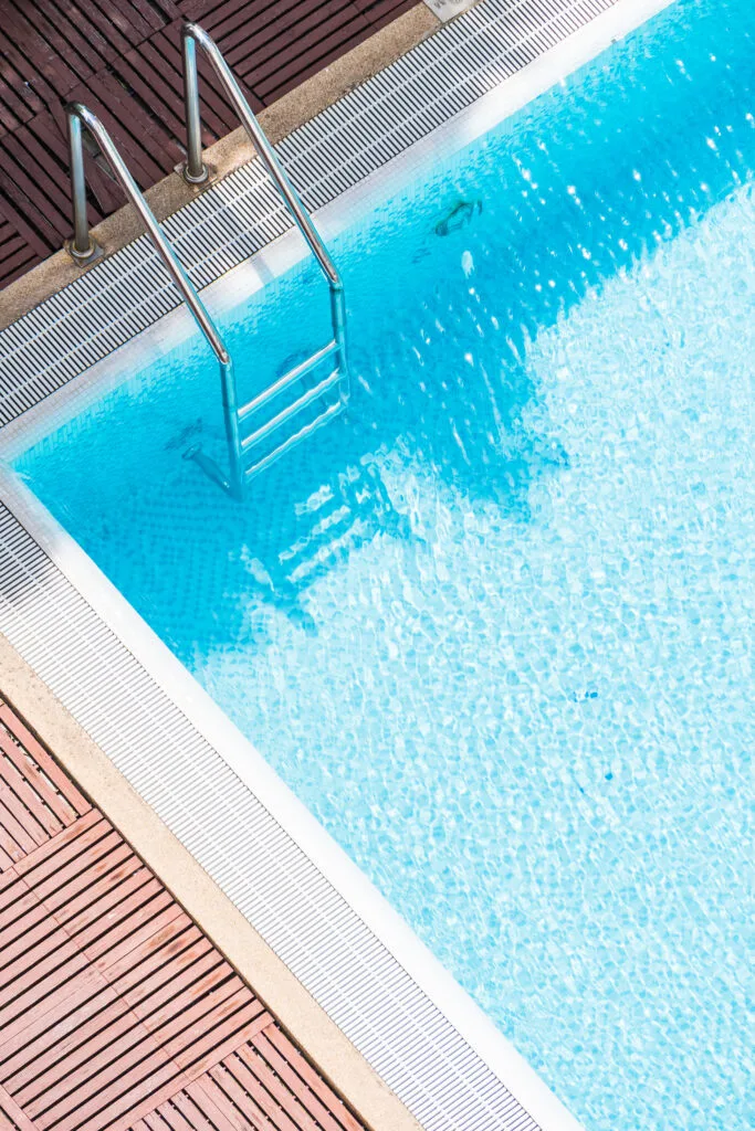 Swimming pool corner with a metal ladder